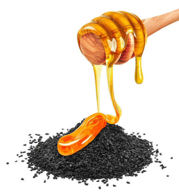 50795738 - black cumin with honey isolated on a white background 50795738 - black cumin with honey isolated on a white background