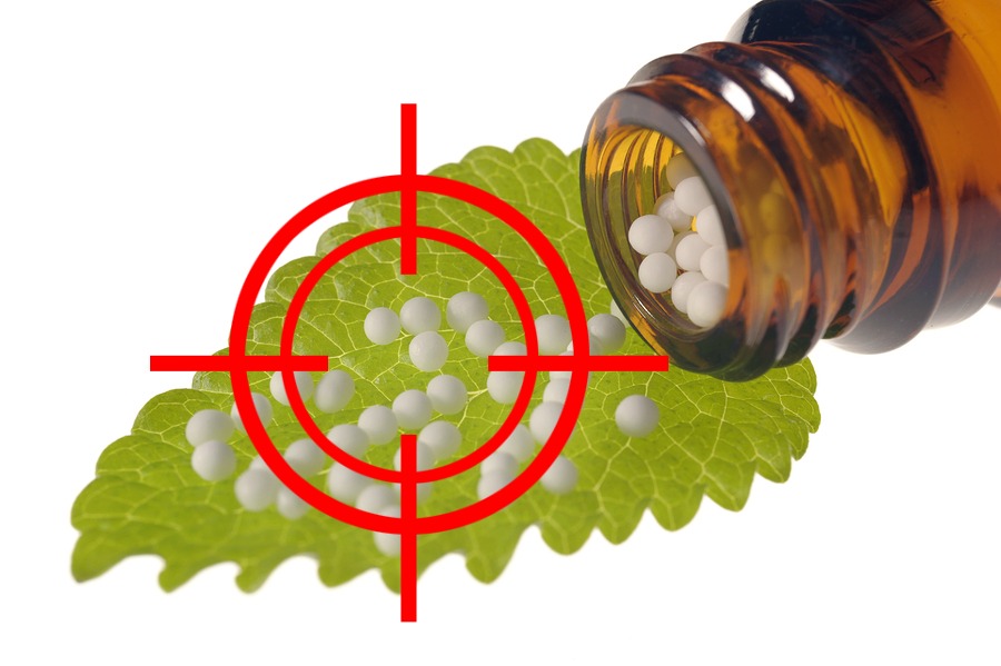 alternative medicine and homeopathy with herbal globules on leaf
