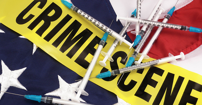 Syringes And Crime Scene Cordon Tape Over American Flag